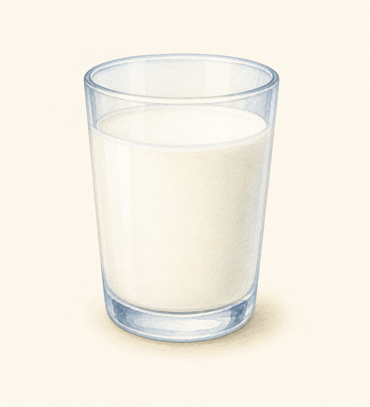 A clear glass filled with white milk.